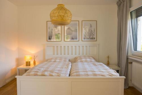 a white bed with two pillows on it in a bedroom at Ferien in Neviges in Velbert