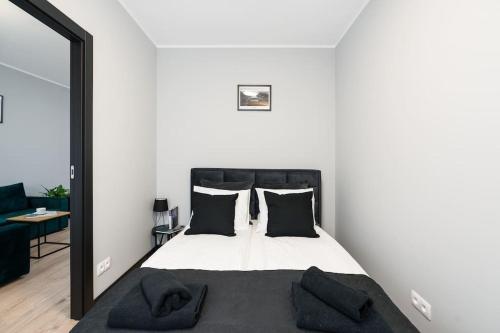a bedroom with a bed with a black headboard at Tumsky14 in Poznań
