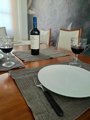 a table with a bottle of wine and two glasses at Apartamento Rufina VII pleno centro San Luis in San Luis
