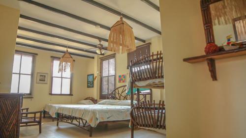 a bedroom with a bunk bed and a spiral staircase at Hostería Ecológica El Faro in Salinas