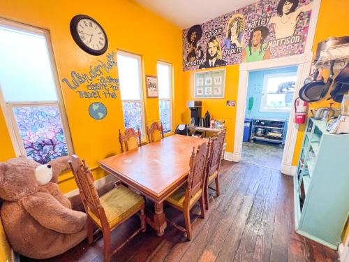 a dining room with a wooden table and a teddy bear at ITH San Diego Adventure Hostel in San Diego