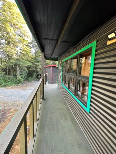 a walkway leading to a building with a window at Molco Cabins Palafito in Pucón