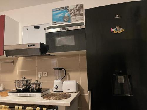 a kitchen with a counter with a stove and a blender at Séjour confortable et agréable pour la famille... in Étampes