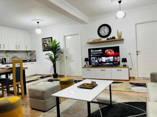a living room with a tv and a table at Daily rent apartment city center Elbasan 6 in Elbasan