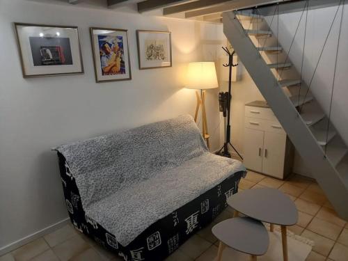 a bedroom with a bed and a staircase at Cocooning in Samois-sur-Seine