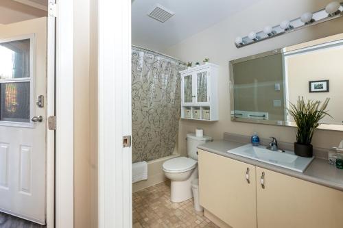 a bathroom with a toilet and a sink at Seascape Suite by IRIS PROPERTIES! in Sooke