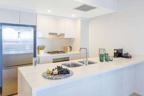 a kitchen with a sink and a plate of fruit at Meriton Suites Herschel Street, Brisbane in Brisbane
