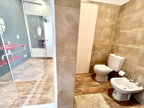 a bathroom with a toilet and a glass shower at Anubis in Merlo