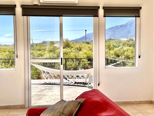 a bedroom with a hammock in front of a window at Anubis in Merlo