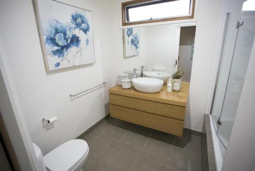 a bathroom with a sink and a toilet at SUNNY DAZE in Point Lonsdale