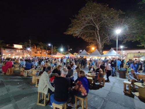 a crowd of people sitting at tables at night at Pousada L'étage in Búzios