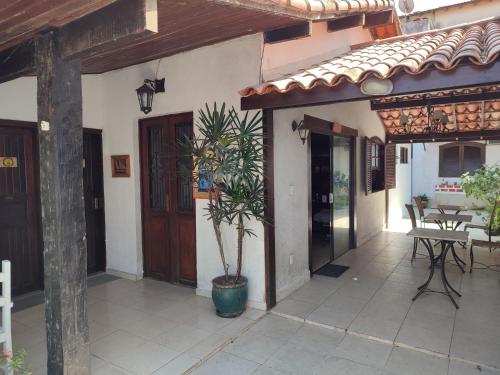 a house with a potted plant on a patio at Pousada L'étage in Búzios