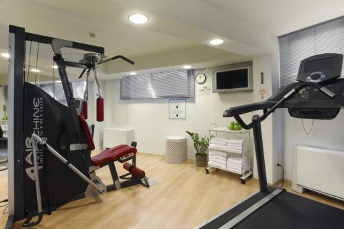 a room with a gym with a treadmill at Hotel Imperiale Rimini & SPA in Rimini