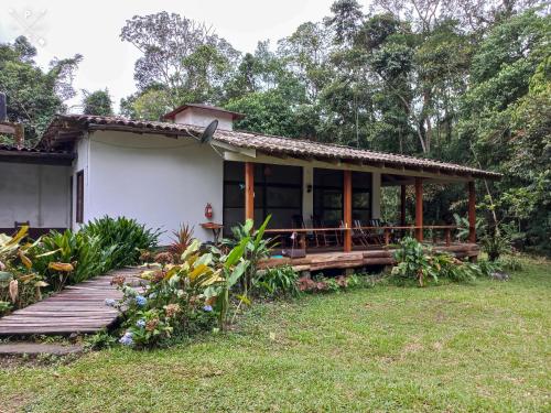 uma casa com um alpendre em madeira e um quintal em Wandari Lodge em Quince Mil