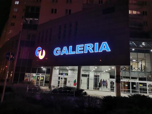 a cal retailer sign in front of a building at Gallery Apartament in Warsaw
