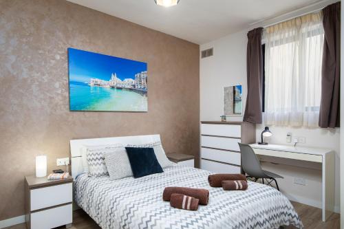a bedroom with a bed and a desk and a sink at Luxury Msida Circle Suites in Msida