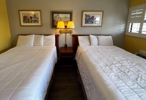 two beds sitting next to each other in a room at Motel 6 San Francisco CA Fisherman"s Wharf in San Francisco