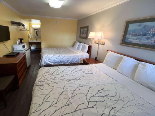 a hotel room with two beds and a desk at Motel 6 San Francisco CA Fisherman"s Wharf in San Francisco