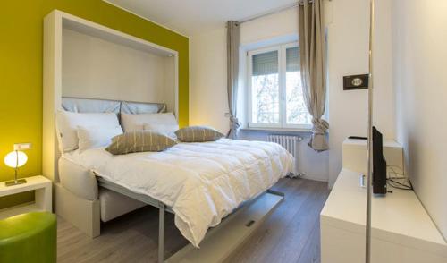 1 dormitorio con 1 cama y TV en Apartment Melozzo, en Milán