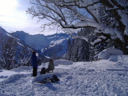 a couple of people standing in the snow at Hotel-Gasthof Der Wiesengrund in Bad Hindelang