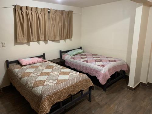 two beds sitting next to each other in a room at 9 de octubre in Oruro