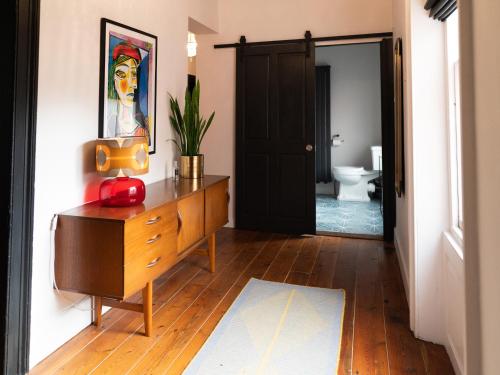 a hallway with a dresser and a bathroom with a toilet at No 2 Pepper Arden in Northallerton