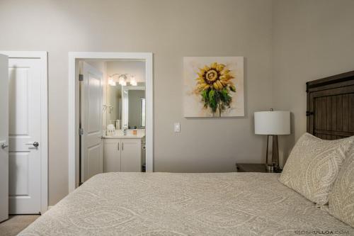a bedroom with a bed and a bathroom with a sink at S404-The Penthouse-Fourth Floor 3-bedroom Pool View in St. George