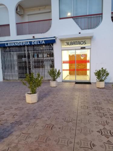 a store front with potted plants in front of it at Empuriabrava Vue Mer in Empuriabrava