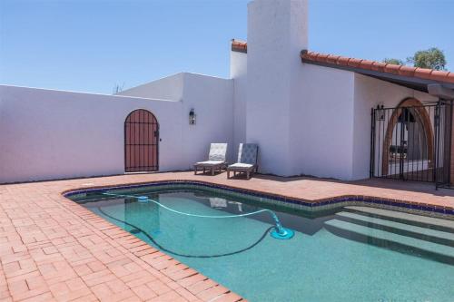 a swimming pool in front of a house at Spacious Arcadia Lite house w pool mtn views in Phoenix