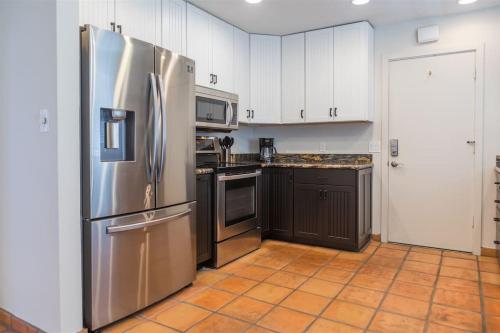 a kitchen with a stainless steel refrigerator and cabinets at Spacious Arcadia Lite house w pool mtn views in Phoenix