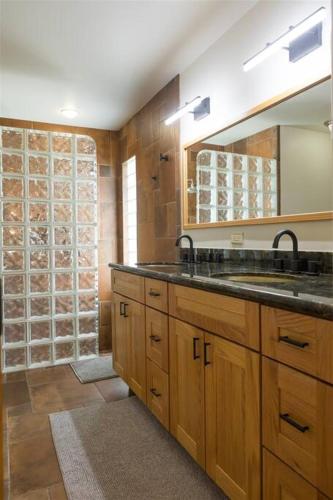 a bathroom with a sink and a shower at Spacious Arcadia Lite house w pool mtn views in Phoenix