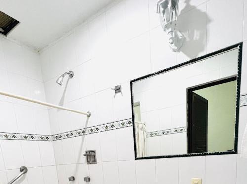 a bathroom with a mirror and a shower at Hotel Nueva Antequera in Oaxaca City