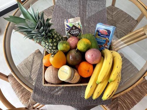a basket of fruits and vegetables on a table at Kay Sandra à 2 mn du CHU in Saint-Joseph
