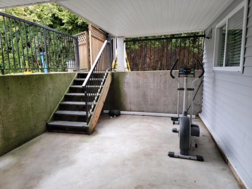 an empty patio with a stairway and a railing at Oscar INN & 2bd Family Suite or Private Room in Abbotsford