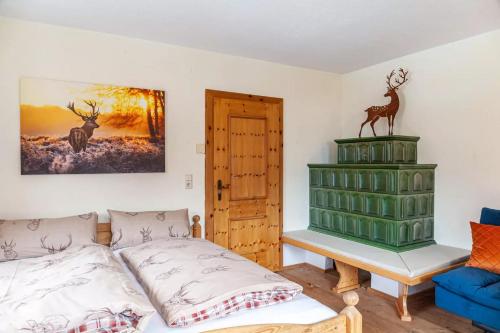 a bedroom with a bed and a cabinet with a deer statue on it at Ferienwohnung Platzhirsch Panorama View Balkon, Gartensauna, Garten, Grillplatz in Stumm