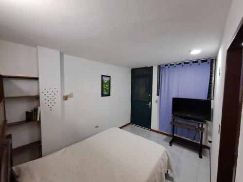 Un dormitorio con una cama y un piano. en Sorokaima, en Caracas