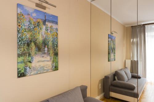 a living room with a painting on the wall at Cinema Flat Centrally Located in Warsaw