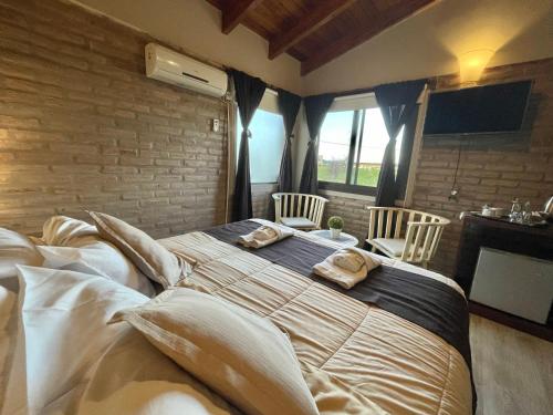 a bedroom with a large bed with two towels on it at Agrippina in Villa Carlos Paz