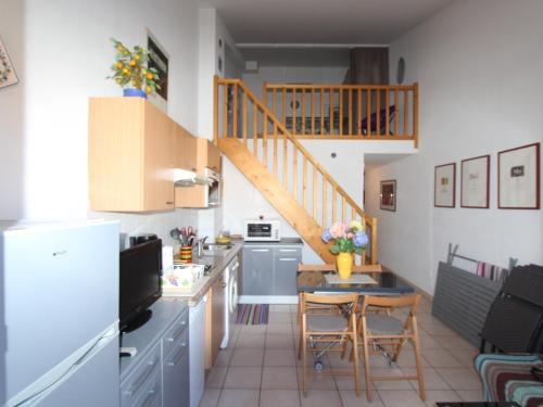a kitchen with a small table and a staircase at Appartement Argelès-sur-Mer, 3 pièces, 4 personnes - FR-1-309-172 in Argelès-sur-Mer