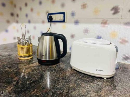 a toaster sitting on a counter next to a toaster at Lovely 2bed room AC apartment JP Nagar in Bangalore