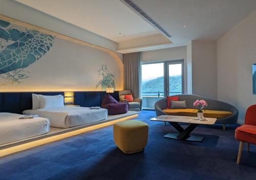 a hotel room with a bed and a couch at The Archipelago in Toucheng