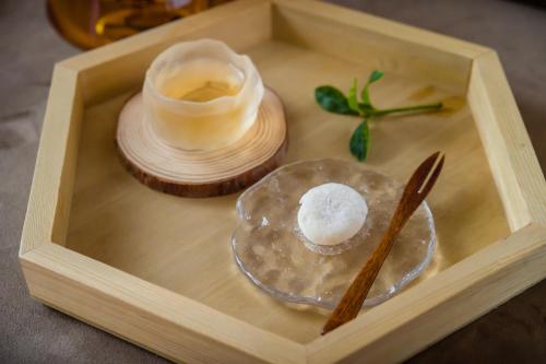 a wooden box with a bowl of soap and a wooden spoon at Taitung Puyuma Style Inn in Taitung City