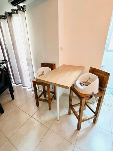 a wooden table and chairs in a room at Beautiful Condo in La Romana with pool near Caleta Beach in La Romana