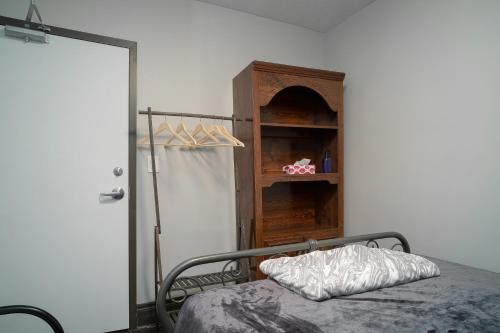 a bedroom with a bed and a book shelf at Room #3 Ottawa downtown in Ottawa