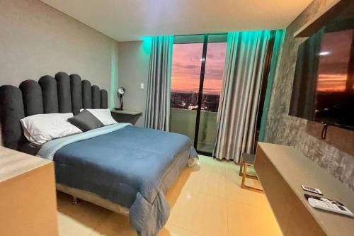 a bedroom with a bed and a large window at Dpto lujoso, comodo e intimo cerca de todo in Santa Cruz de la Sierra