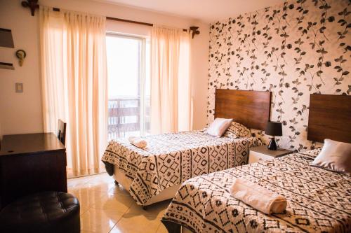 Säng eller sängar i ett rum på Hospedaje Casa Bonita Frente al Mar