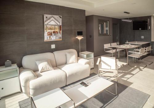 a living room with a couch and a table at Y COLLECTION by UH FLAT OSIRIA in Busan