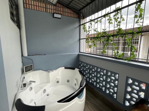 a bath tub in a bathroom with a window at 10Px 5BR V Jaccuzi Spa n KTV n Kids Pool n Pool Table Near USM n Lam Wah Ee Hospital in Gelugor