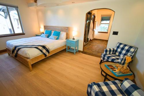 a bedroom with a bed and a couch and a chair at Peppertree Lane Ranch -- Seven-Acre Ranch in the Heart of Wine Country in Temecula