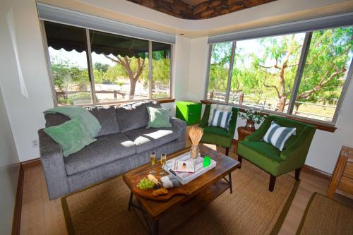 a living room with a couch and two chairs at Peppertree Lane Ranch -- Seven-Acre Ranch in the Heart of Wine Country in Temecula